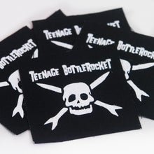 Load image into Gallery viewer, Image of several black patches against a white background. The patch says teenage bottlerocket in white text and below that is the teenage bottlerocket logo of a skull with cross arrows, also in white.
