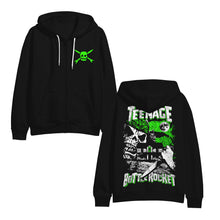 Load image into Gallery viewer, Image of the front and back of a black hooded sweatshirt against a white background. The front of the sweatshirt has white strings. The left chest has the teenage bottlerocket logo of a skull head with cross arrows. The back of the sweatshirt says teenage bottlerocket in white distressed letters with a green outline. teenage is at the top, bottlerocket is at the bottom. In the middle of these words is a giant skull face looking at a haunted house. There is a full moon and a person&#39;s hand holding a knife.
