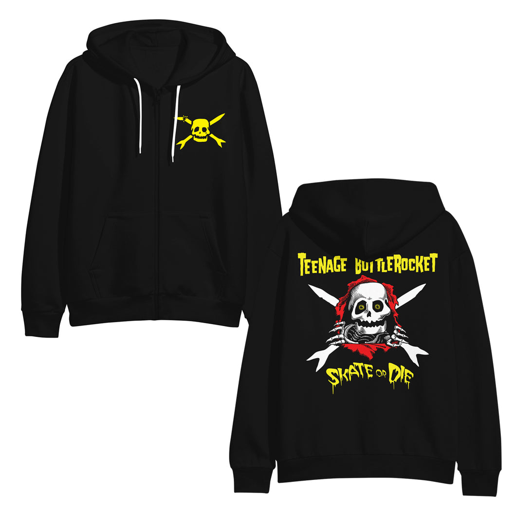 Image of the front and back of a black zip up sweatshirt against a white background. The left chest has the teenage bottlerocket logo in yellow- a skull head with cross arrows. The hoodie has white strings. The back of the hoodie says teenage bottlerocket across the shoulder area in yellow. Below that is an image of a skeleton's face that popped out of a red hole and it has its hands on the edges of it. There are cross arrows in white behind the skeleton. Below this is yellow text that says skate or die.