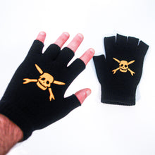 Load image into Gallery viewer, A hand wears a Teenage Bottlerocket black fingerless glove with a yellow skull and crossbones; another matching glove lies flat on a white surface.
