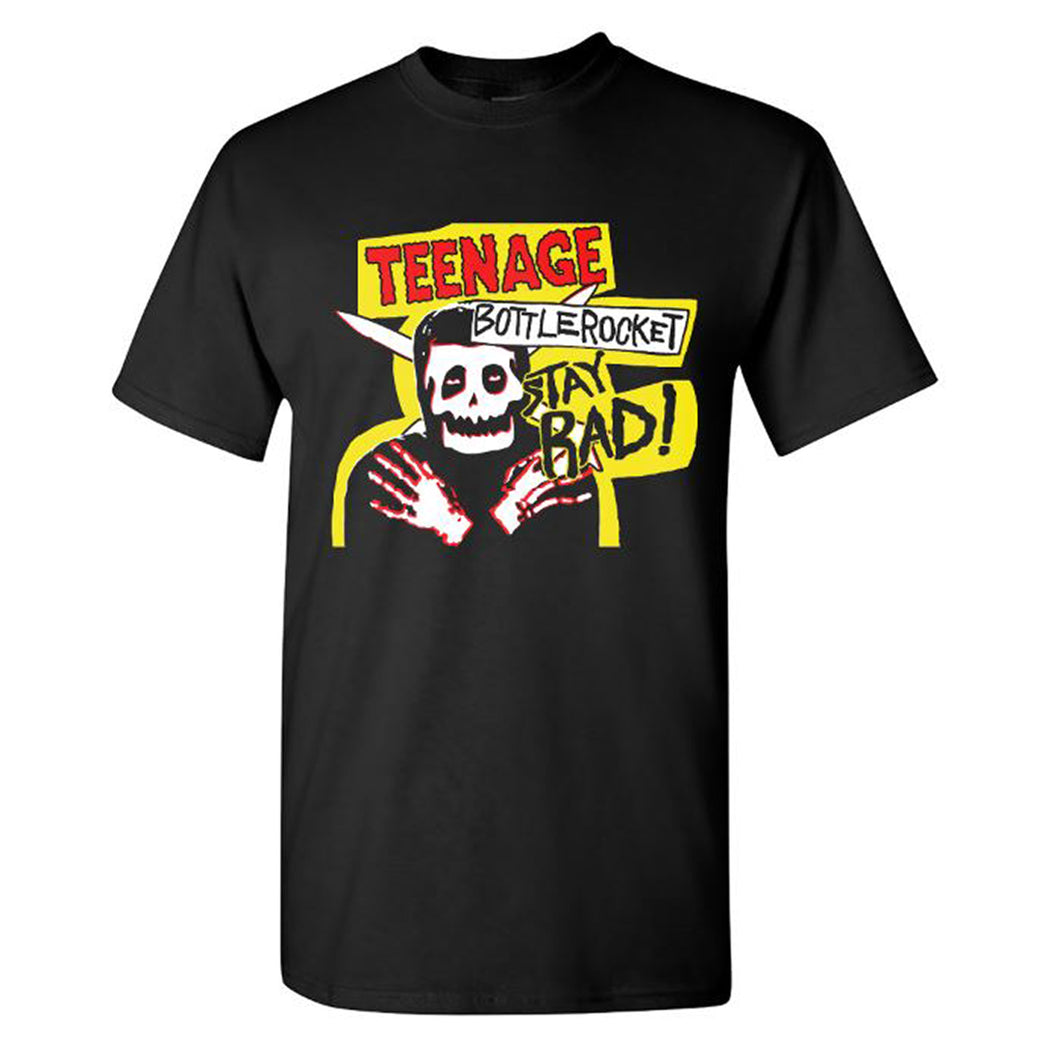 Image of a black tshirt against a white background. The tshirt has an image of a skeleton wearing a black shirt and crossing its arms over its chest. There is cross arrows behind its head. There is a yellow outline around the skeleton and the words teenage bottlerocket, stay rad! The word teenage is in red with a black outline, the word bottlerocket is in black with a white rectangle around it, and the words stay rad are in black with the yellow outline around it. 