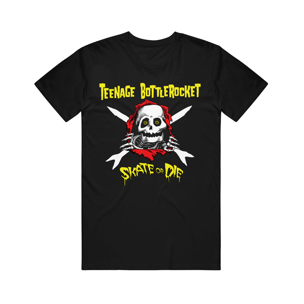 image of a black tee shirt on a white background. the front of the tee has an image of a skeleton's face that popped out of a red hole and it has its hands on the edges of it. There are cross arrows in white behind the skeleton. the top in yellow says teenage bottlerock. the bottom says skate or die