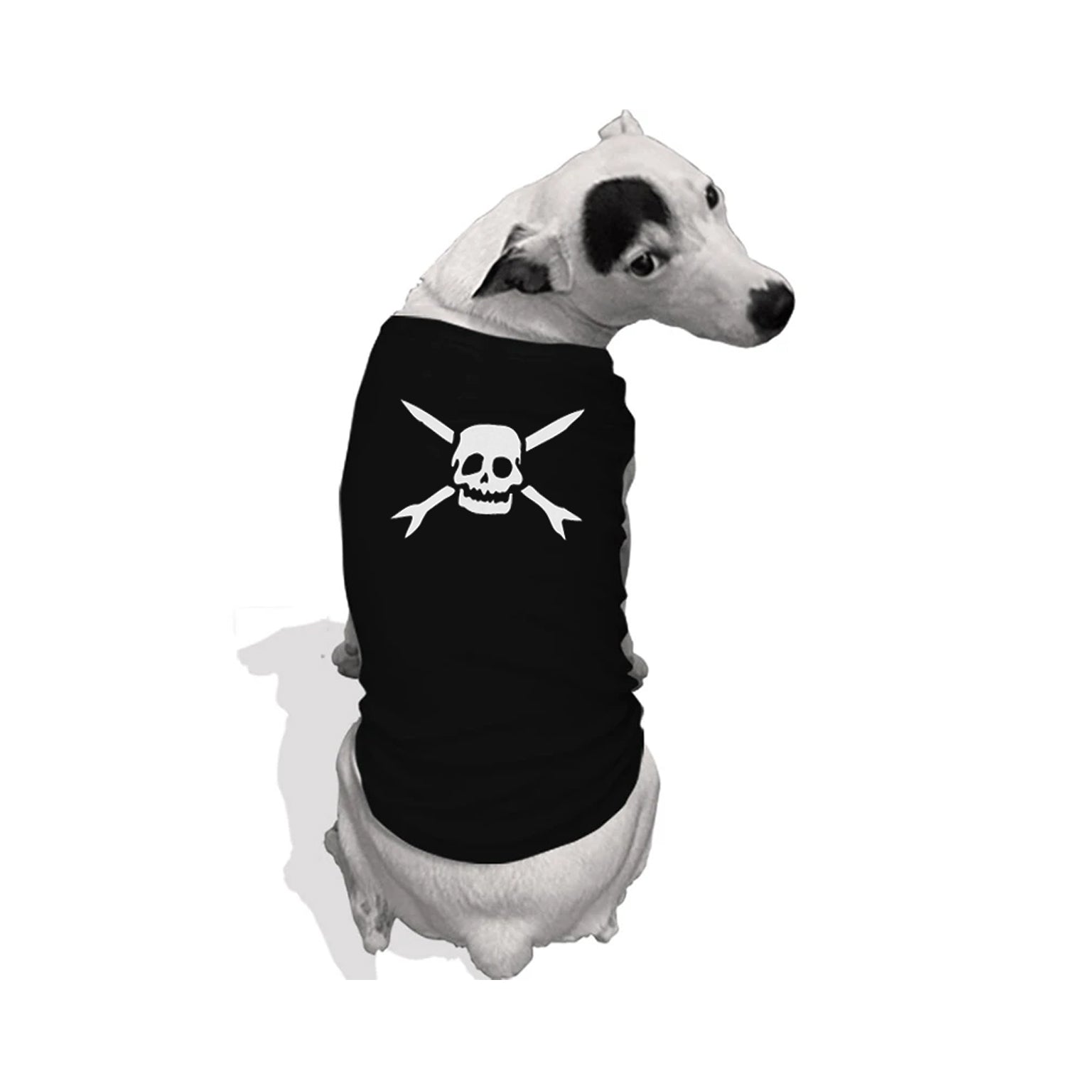 Image of a white dog with black spots on its nose, eye and ear with its back to the camera, head turned to look at the camera. The background is white. The dog is wearing a black dog tank top that features the teenage bottlerocket logo of a skull head with cross arrows in white.