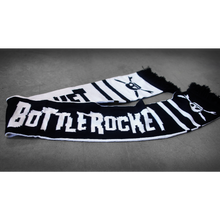 Load image into Gallery viewer, image of a scarf laid flat on a concrete floor. the scarf black with white text that says teenage bottlerocket. each end by the fringe has a skull
